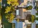 Aerial view of a house with a backyard waterfront, dock, mature trees, and boat access to the canal at 13912 Sommers Ave, Hudson, FL 34667