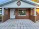 Close up of a house with a decorative front entrance, tiled patio, and unique stucco exterior at 13912 Sommers Ave, Hudson, FL 34667