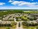 Aerial view of a community with houses, pool, and landscaping at 27563 Pleasure Ride Loop, Wesley Chapel, FL 33544