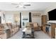 Spacious living room featuring comfortable sofas, a coffee table, and a fireplace at 2132 Shining Azul Way, Lutz, FL 33558