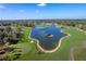 Aerial view of golf course community with lake and homes at 2241 Merion Ct, Spring Hill, FL 34606