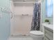 Clean bathroom, shower stall with curtain, toilet and small vanity at 2241 Merion Ct, Spring Hill, FL 34606