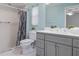 Updated bathroom with gray vanity, shower, and toilet at 2241 Merion Ct, Spring Hill, FL 34606