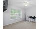 Bright bedroom with large window, ceiling fan, and workspace at 2241 Merion Ct, Spring Hill, FL 34606