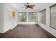 Bright common area with built-in bar, wood-look flooring, and large windows at 2241 Merion Ct, Spring Hill, FL 34606