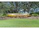 Community entrance sign with landscaping, welcoming residents to Timber Pines at 2241 Merion Ct, Spring Hill, FL 34606