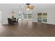 Dining area with wood floors and four black chairs at 2241 Merion Ct, Spring Hill, FL 34606
