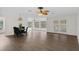Open dining area with hardwood floors and a view of the living room at 2241 Merion Ct, Spring Hill, FL 34606