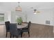 Dining area with round table, four black chairs, and hardwood floors at 2241 Merion Ct, Spring Hill, FL 34606