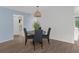 Charming dining area with round table and four chairs, light blue walls, and wood-look flooring at 2241 Merion Ct, Spring Hill, FL 34606