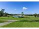 Peaceful golf course view with a pond and mature trees at 2241 Merion Ct, Spring Hill, FL 34606