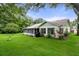 Exterior view of house, highlighting the back screened porch and yard at 2241 Merion Ct, Spring Hill, FL 34606