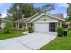 Single-story house with light green exterior and attached garage at 2241 Merion Ct, Spring Hill, FL 34606