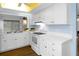 White kitchen with stainless steel appliances and wood floors at 2241 Merion Ct, Spring Hill, FL 34606