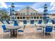 Relaxing pool area with tables, chairs, and umbrellas at 2241 Merion Ct, Spring Hill, FL 34606