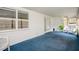 Bright sunroom with blue carpet, wicker chairs, and French doors at 2241 Merion Ct, Spring Hill, FL 34606