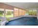 Sunroom with blue carpet, wicker furniture, and backyard view at 2241 Merion Ct, Spring Hill, FL 34606