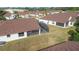House showcasing a screened patio and well-maintained backyard at 9131 Haas Dr, Hudson, FL 34669