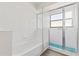 Bathroom with shower and white tile at 9131 Haas Dr, Hudson, FL 34669