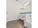Bathroom with teal vanity and tub/shower combo at 9131 Haas Dr, Hudson, FL 34669