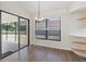 Bright dining area with wood floors, sliding glass doors, and built-in shelving at 9131 Haas Dr, Hudson, FL 34669