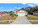 House exterior showcasing front yard and driveway at 9131 Haas Dr, Hudson, FL 34669