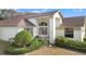 Attractive home exterior featuring a covered entryway and manicured landscaping at 9131 Haas Dr, Hudson, FL 34669