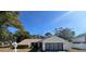 Tan one-story house with attached garage and a spacious yard at 11164 Paco St, Spring Hill, FL 34609