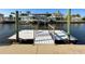 White floating dock with steps leading to the water at 6530 Driftwood Dr, Hudson, FL 34667