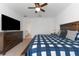 Large bedroom with ensuite bathroom and TV at 12931 Conquistador Loop, Spring Hill, FL 34610