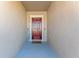 Red front door entryway with welcome mat and sign at 12931 Conquistador Loop, Spring Hill, FL 34610