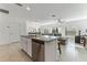 Kitchen island with seating and view into the living room at 12931 Conquistador Loop, Spring Hill, FL 34610