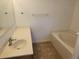 Bathroom featuring a vanity, tub, and tiled floor at 6075 Shingler Ave, Spring Hill, FL 34608