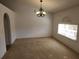 Spacious dining room featuring a chandelier and large window at 6075 Shingler Ave, Spring Hill, FL 34608