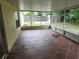 Screened porch with tiled floor and backyard view at 6075 Shingler Ave, Spring Hill, FL 34608