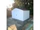 White metal storage shed with brown roof at 6075 Shingler Ave, Spring Hill, FL 34608