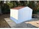 White metal storage shed with brown roof at 6075 Shingler Ave, Spring Hill, FL 34608