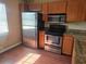 Well-equipped kitchen with stainless steel appliances and wood cabinets at 5265 E Bay Dr # 420, Clearwater, FL 33764