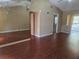 Spacious living room featuring hardwood floors and a large mirror at 5265 E Bay Dr # 420, Clearwater, FL 33764