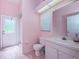 Pink bathroom with shower, toilet and single sink vanity at 8233 Danubian Pl, Trinity, FL 34655