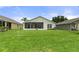 Spacious backyard with grassy area and home view at 11724 Heritage Point Dr, Hudson, FL 34667