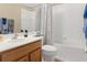 Clean and bright bathroom with a shower/tub combo and wood vanity at 11724 Heritage Point Dr, Hudson, FL 34667