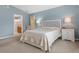 Bright bedroom with ensuite bathroom access and neutral decor at 11724 Heritage Point Dr, Hudson, FL 34667
