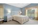 Serene bedroom with a queen-size bed and ample natural light at 11724 Heritage Point Dr, Hudson, FL 34667
