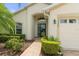 Inviting home exterior with a brick walkway leading to the front door and a two-car garage at 11724 Heritage Point Dr, Hudson, FL 34667