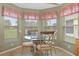 Charming kitchen breakfast nook with a glass-top table and views of the backyard at 11724 Heritage Point Dr, Hudson, FL 34667
