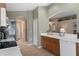Modern kitchen featuring ample counter space, wooden cabinetry, and a breakfast bar at 11724 Heritage Point Dr, Hudson, FL 34667