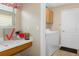 Convenient laundry room with washer, dryer, and storage at 11724 Heritage Point Dr, Hudson, FL 34667