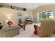 Relaxing living room with comfortable seating, large TV, and views of the backyard at 11724 Heritage Point Dr, Hudson, FL 34667