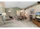 Open-concept living room with neutral decor and access to other living spaces at 11724 Heritage Point Dr, Hudson, FL 34667